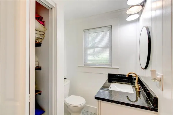 a view of a yard in front of a house with a large tree