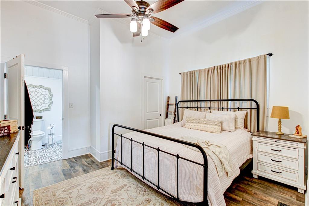 226 Mill Street Bowdon, GA 30108 - Photo 44 of 62 a bedroom with a large bed and a chandelier