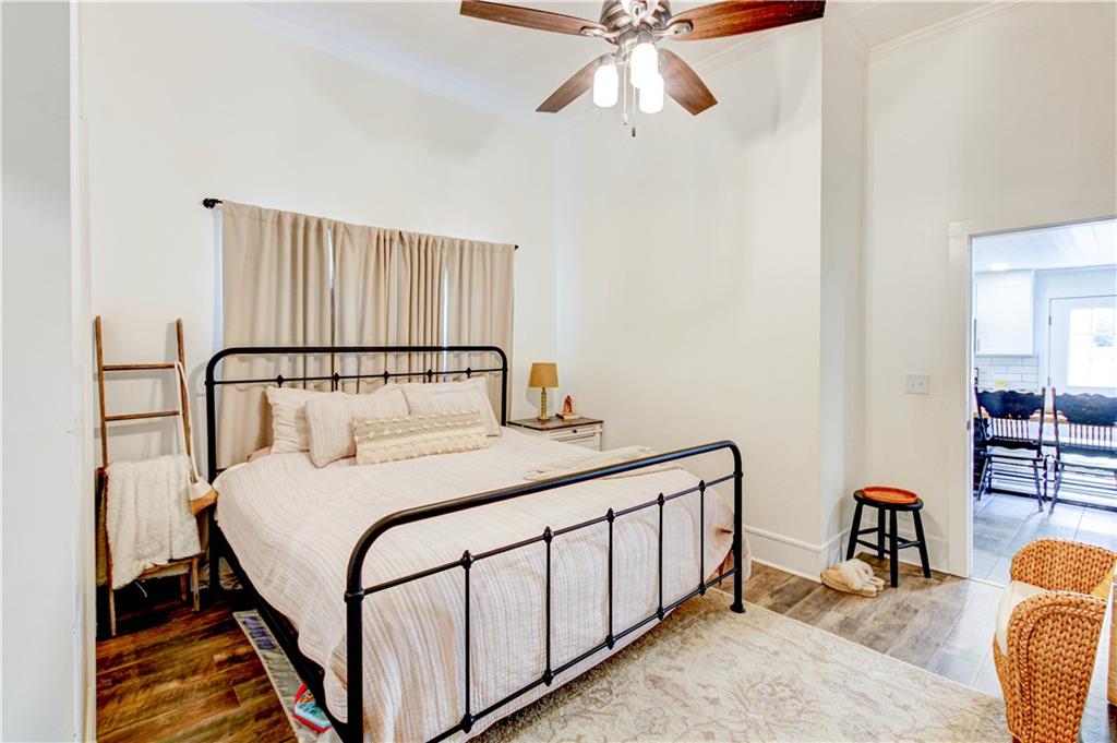 226 Mill Street Bowdon, GA 30108 - Photo 45 of 62 a bedroom with a bed and a chandelier