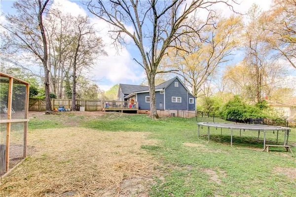 a view of a chair and table in the backyard