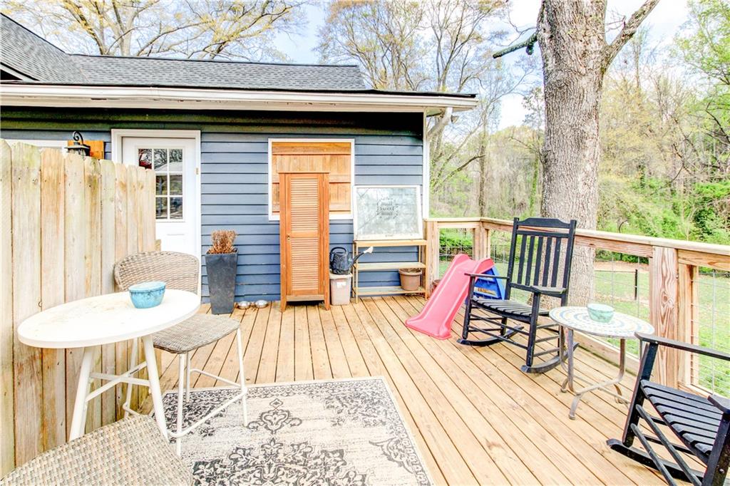 226 Mill Street Bowdon, GA 30108 - Photo 58 of 62 a view of a patio with a table chairs and wooden floor