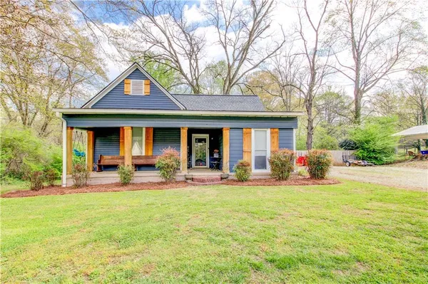 a front view of a house with patio and yard
