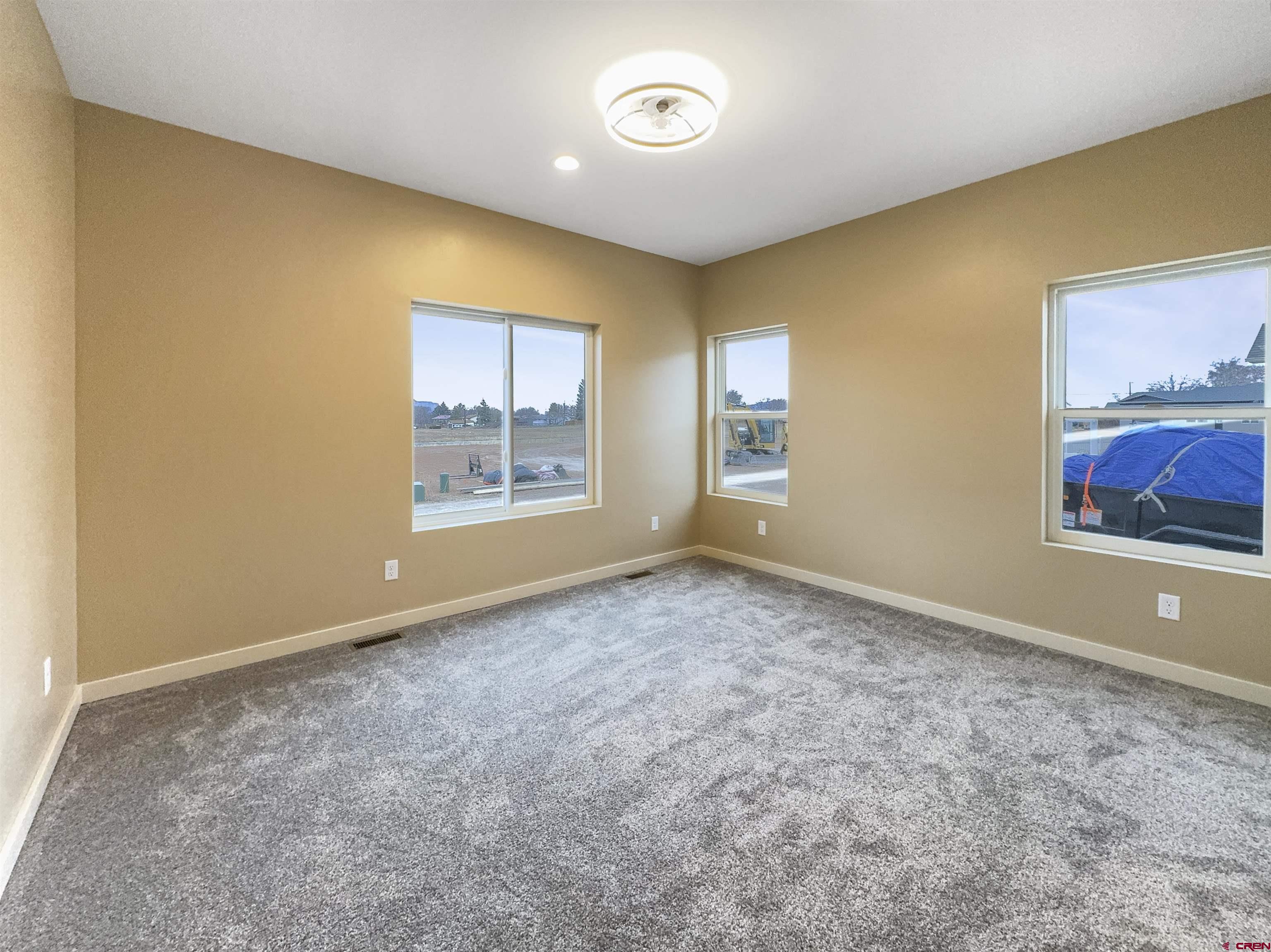 511 Juniper Place Cortez, CO 81321 - Photo 16 of 36 an empty room with windows and closet