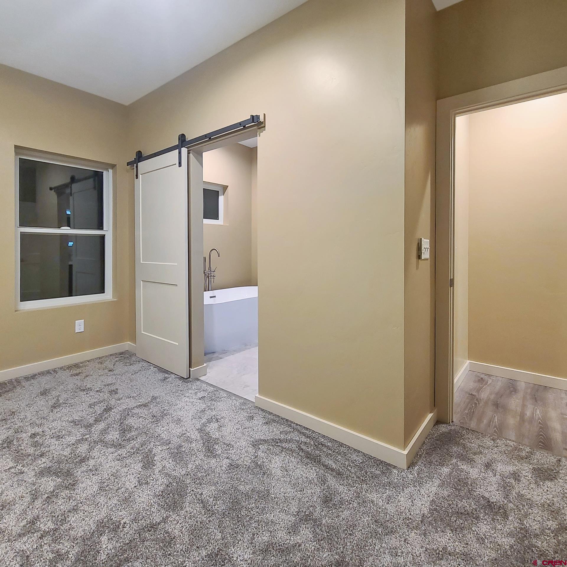 511 Juniper Place Cortez, CO 81321 - Photo 18 of 36 an empty room with closet and windows