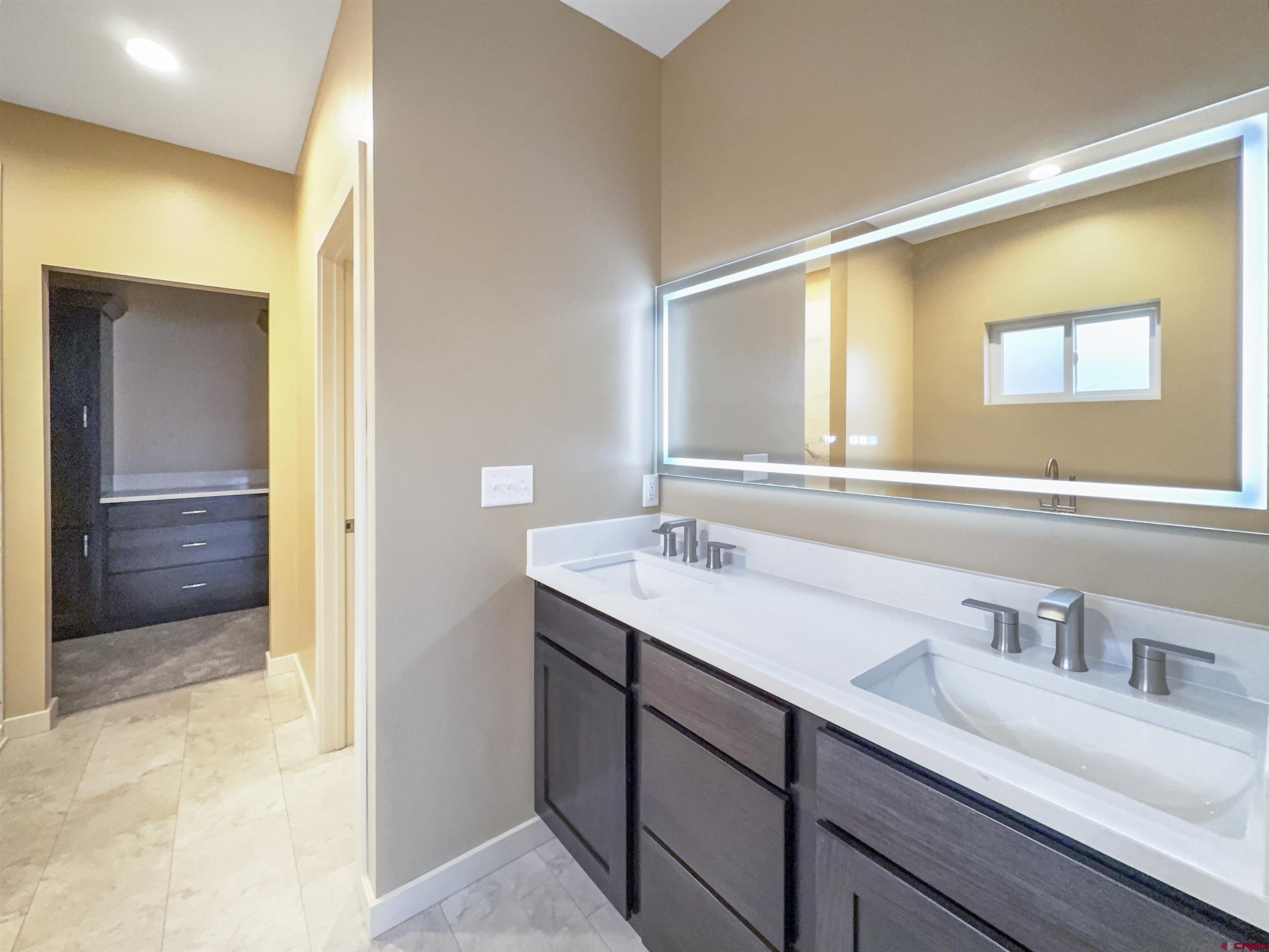 511 Juniper Place Cortez, CO 81321 - Photo 22 of 36 a bathroom with a sink and a mirror