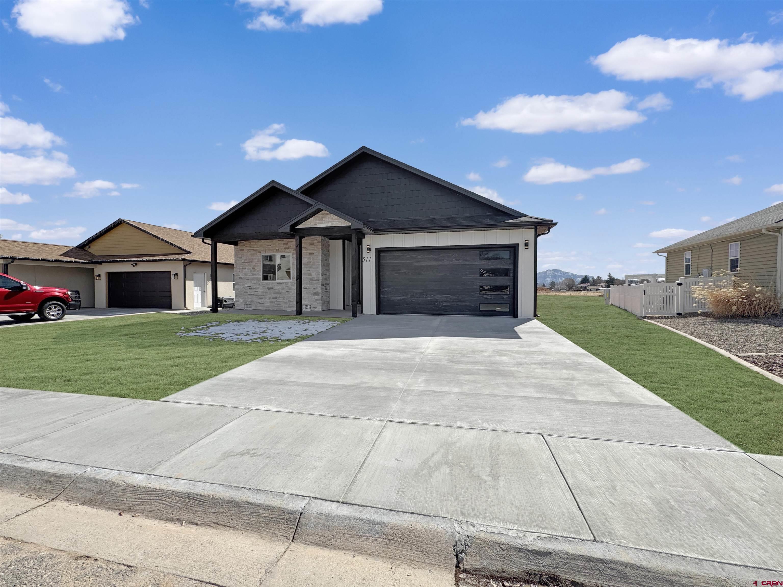 511 Juniper Place Cortez, CO 81321 - Photo 3 of 36 a front view of a house with a yard and garage