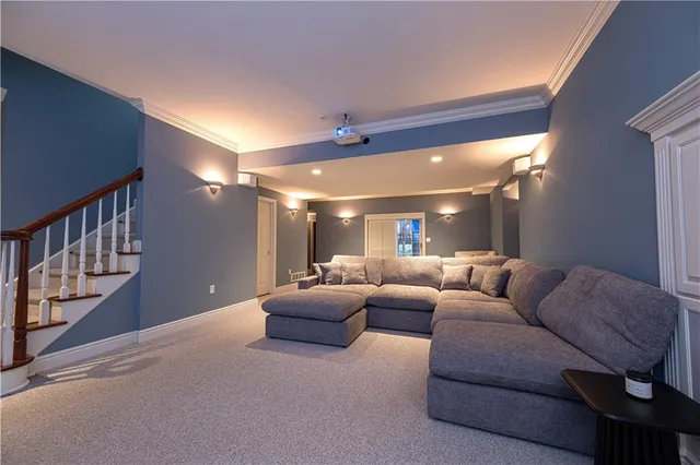 a living room with furniture and a chandelier