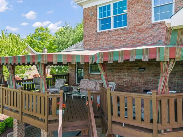 a house with green field in front of it