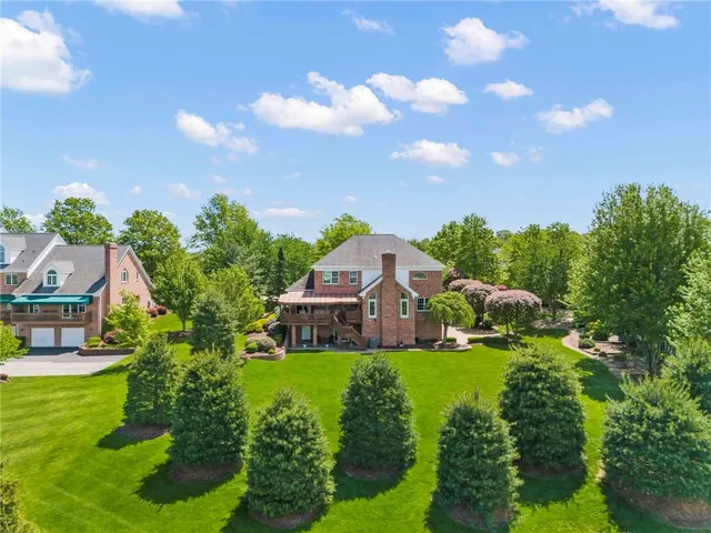 a view of a house with a yard and garden
