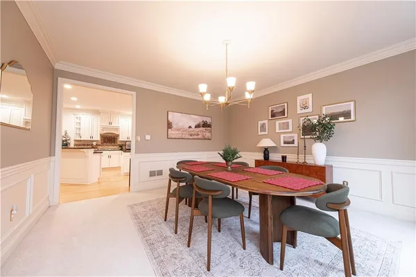 a view of a dining room with furniture and chandelier