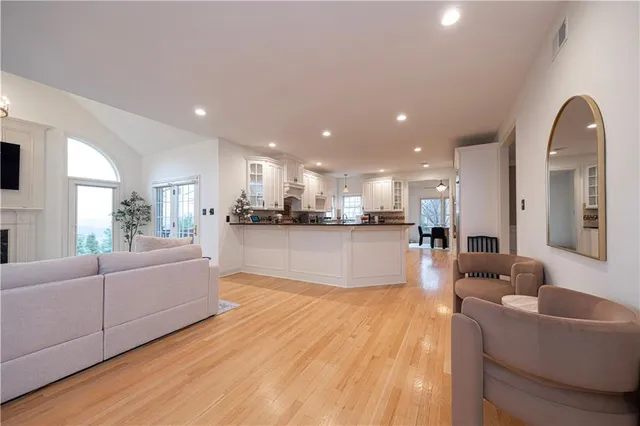 a living room with furniture and kitchen view
