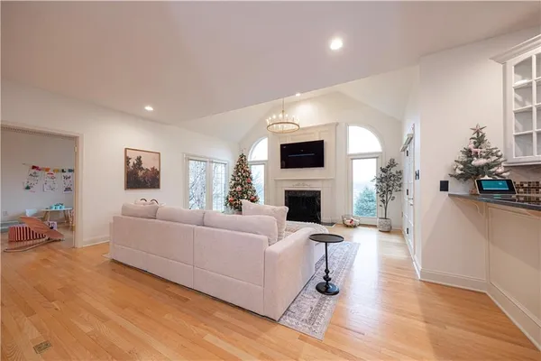 a living room with furniture a fireplace and a flat screen tv