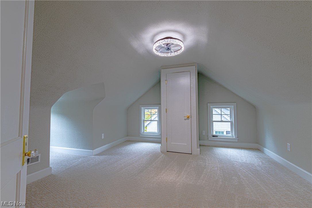 2923 Huntington Road Cleveland, OH 44120 - Photo 30 of 35 Additional living space featuring vaulted ceiling and light carpet