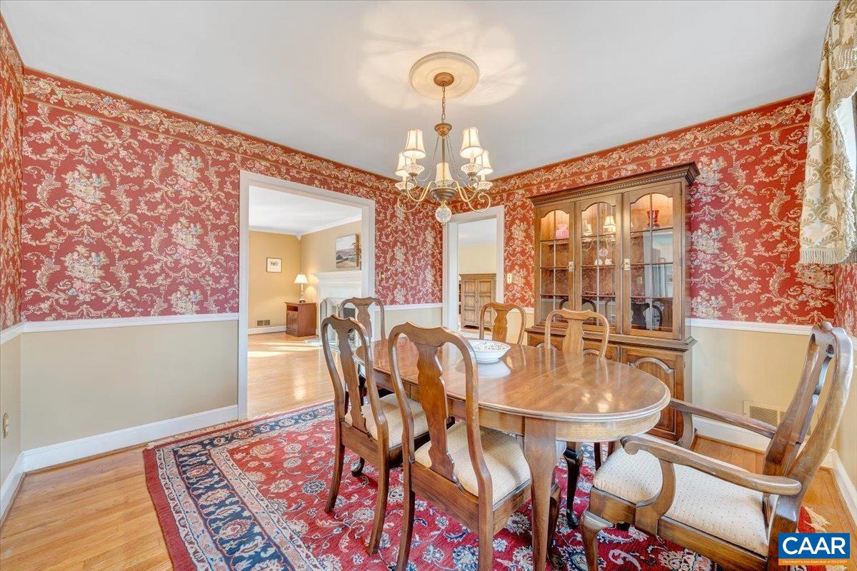 3558 Hartland Road Southwest Roanoke, VA 24015 - Photo 15 of 73 a dining room with wooden floor and a chandelier