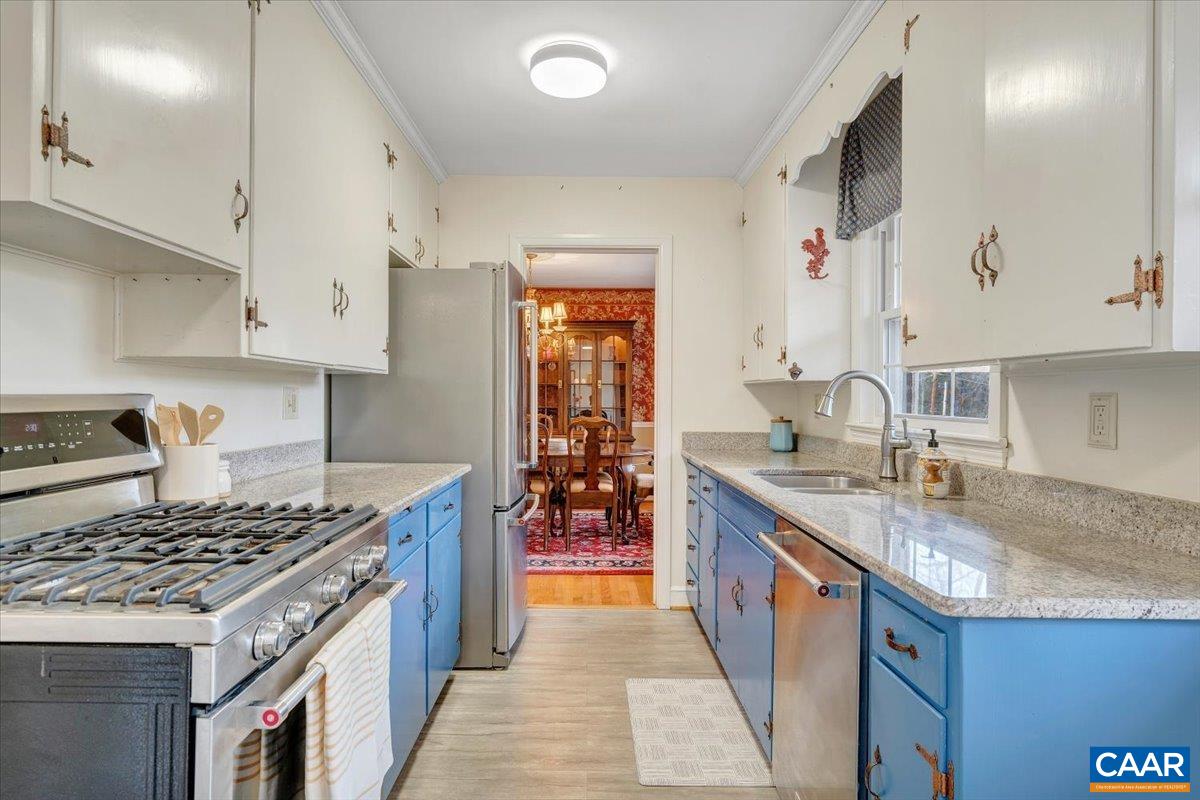 3558 Hartland Road Southwest Roanoke, VA 24015 - Photo 29 of 73 a kitchen with granite countertop a sink stove and cabinets