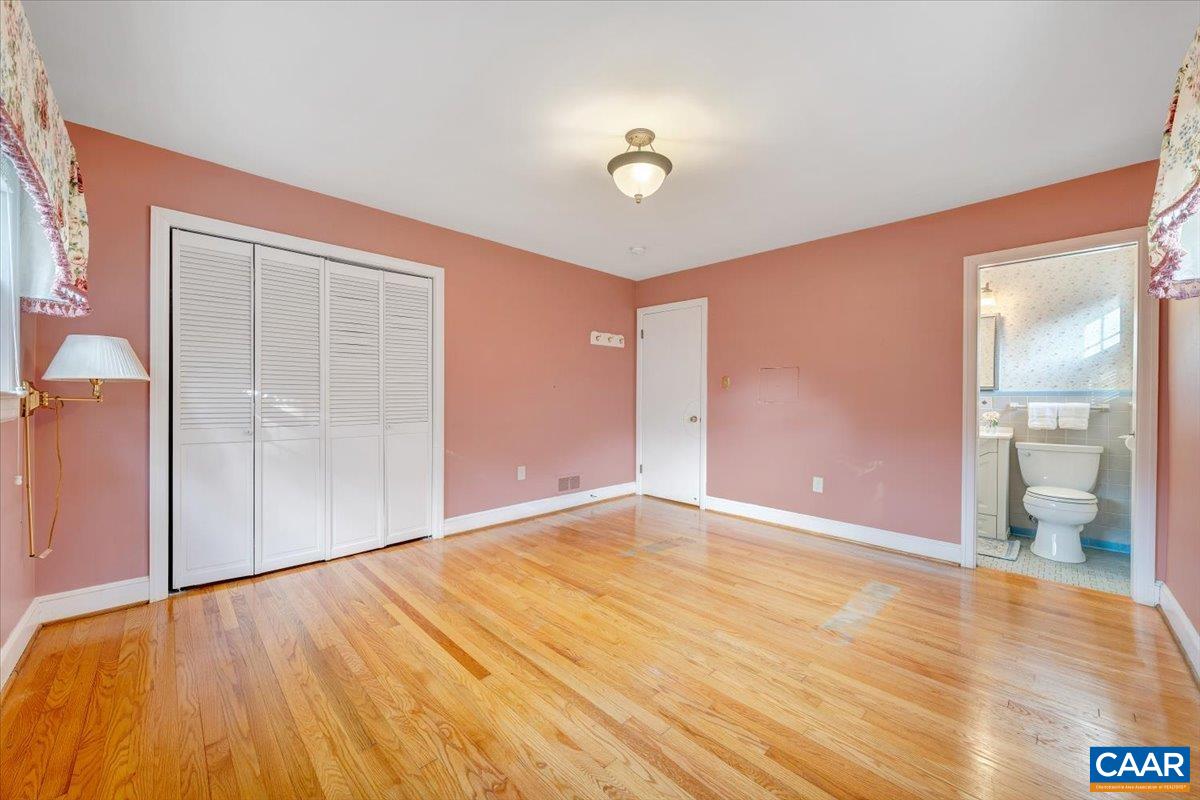 3558 Hartland Road Southwest Roanoke, VA 24015 - Photo 34 of 73 an empty room with wooden floor and door