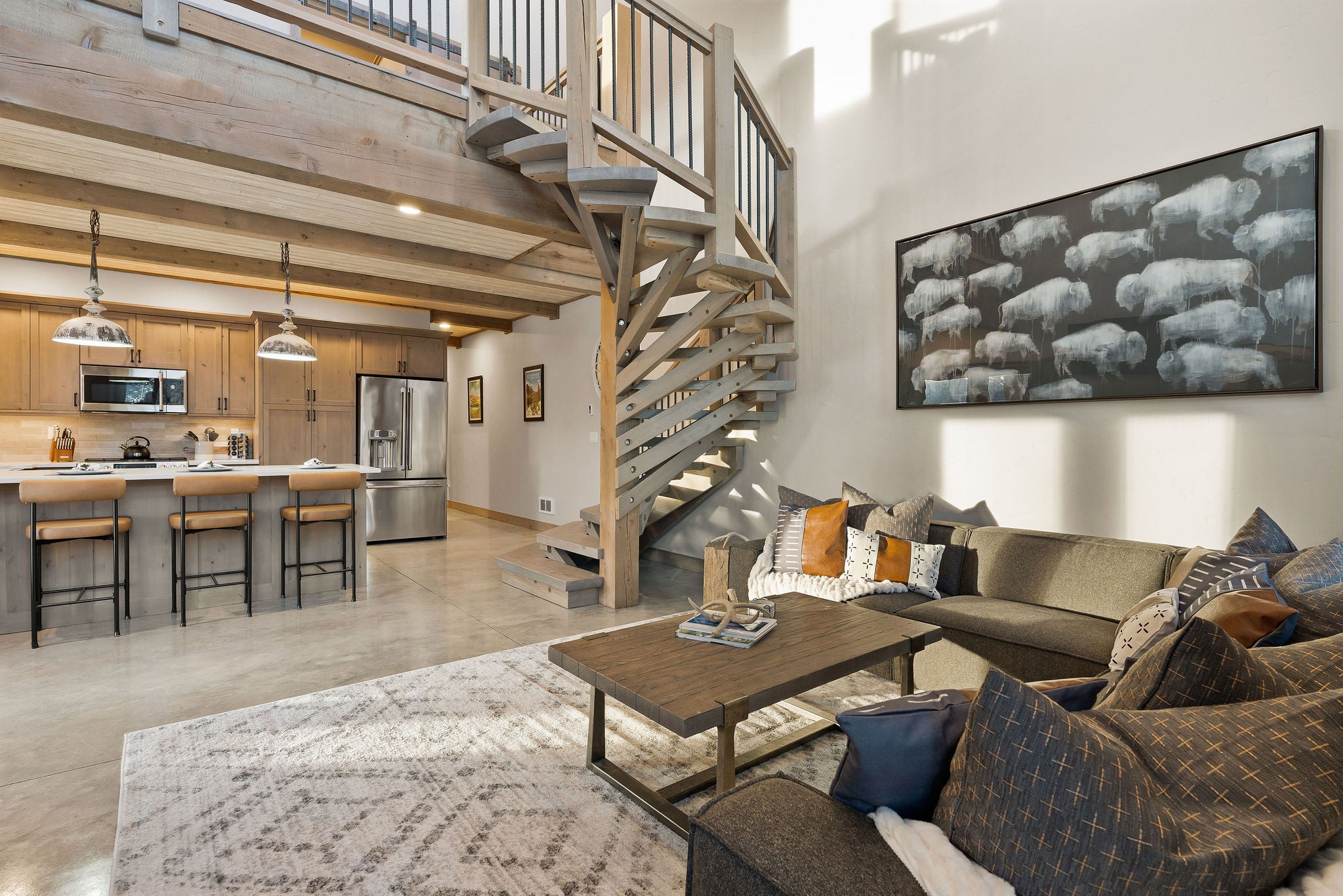 Living area with concrete floors and a high ceiling