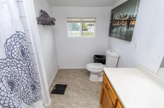 a bathroom with a toilet and a shower curtain