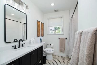 919 Southwest 6th Avenue Gainesville, FL 32601 - Photo 11 of 17 a bathroom with a sink toilet and shower