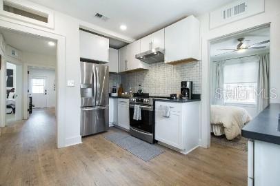 919 Southwest 6th Avenue Gainesville, FL 32601 - Photo 4 of 17 a kitchen with stainless steel appliances a refrigerator sink and cabinets