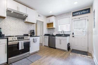 919 Southwest 6th Avenue Gainesville, FL 32601 - Photo 5 of 17 a kitchen with a stove top oven and cabinets