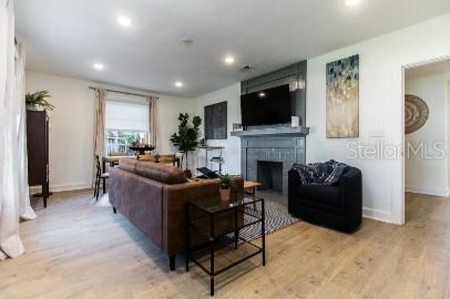 919 Southwest 6th Avenue Gainesville, FL 32601 - Photo 6 of 17 a living room with furniture a flat screen tv and a fireplace