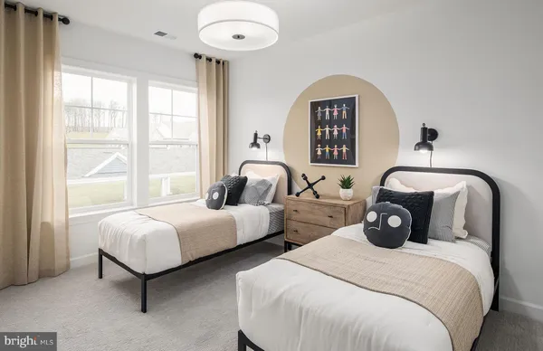 a bedroom with two beds and a large window