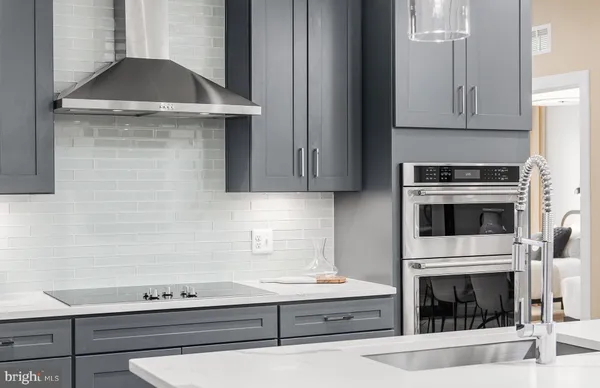a kitchen with granite countertop a sink and a stove top oven