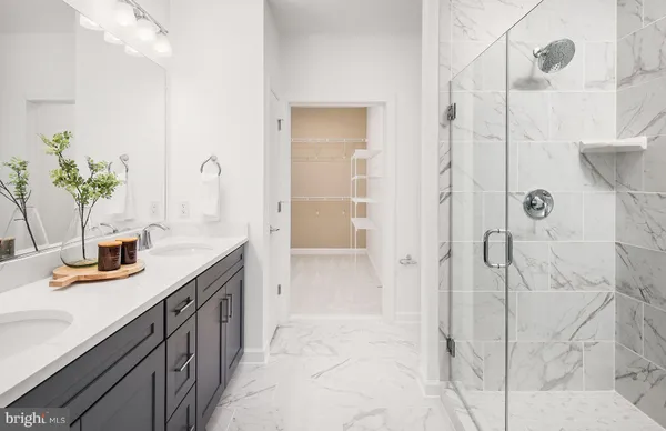 a spacious bathroom with a shower sink and mirror