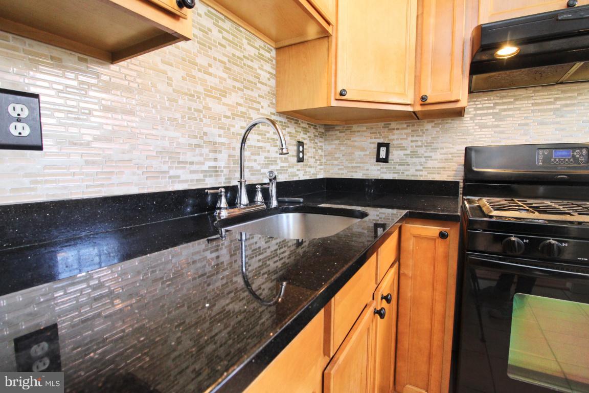 24 Hampton Road Linthicum Heights, MD 21090 - Photo 2 of 23 a kitchen with granite countertop a sink and a stove