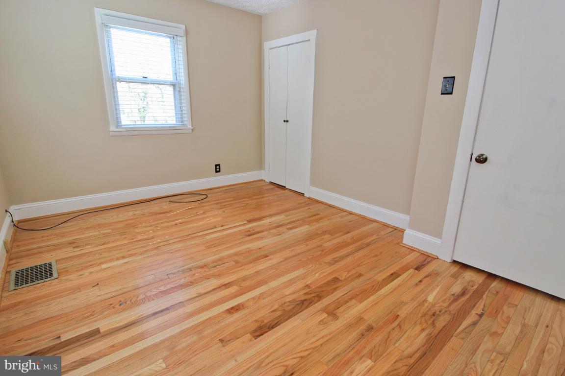 24 Hampton Road Linthicum Heights, MD 21090 - Photo 14 of 23 a view of empty room with wooden floor and fan