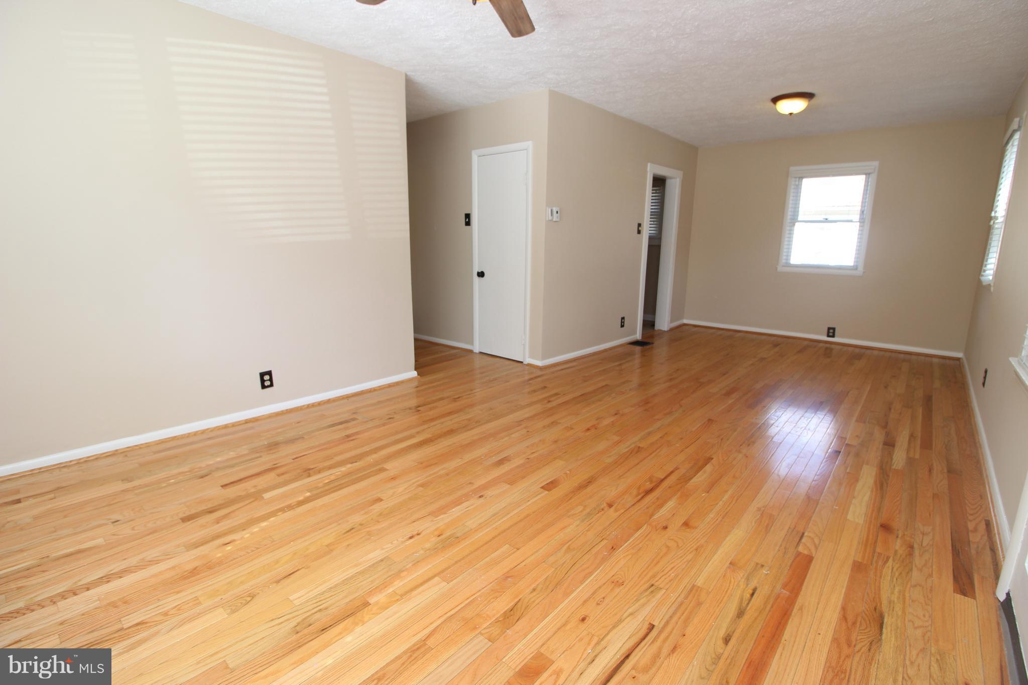 24 Hampton Road Linthicum Heights, MD 21090 - Photo 4 of 23 a view of an empty room and wooden floor