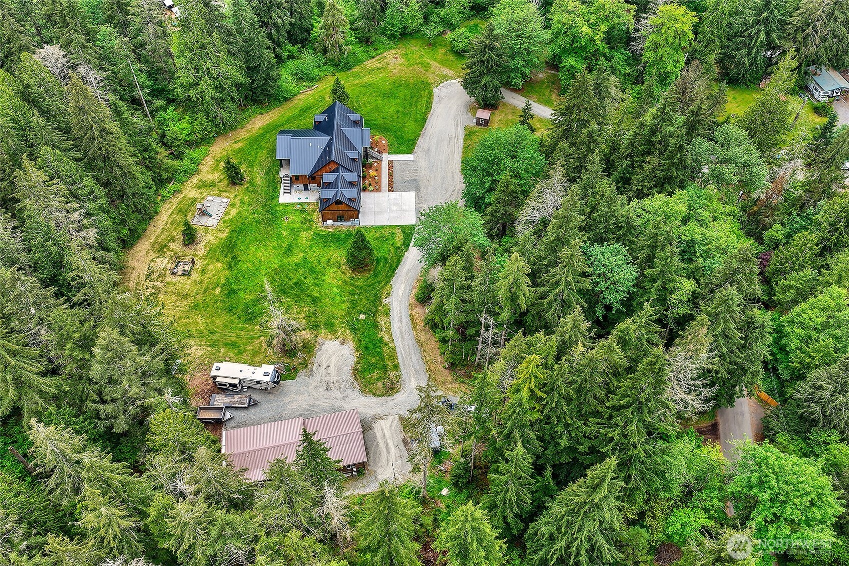 7538 Moon Valley Road Southeast North Bend, WA 98045 - Photo 37 of 40 an aerial view of a house with garden space and trees all around