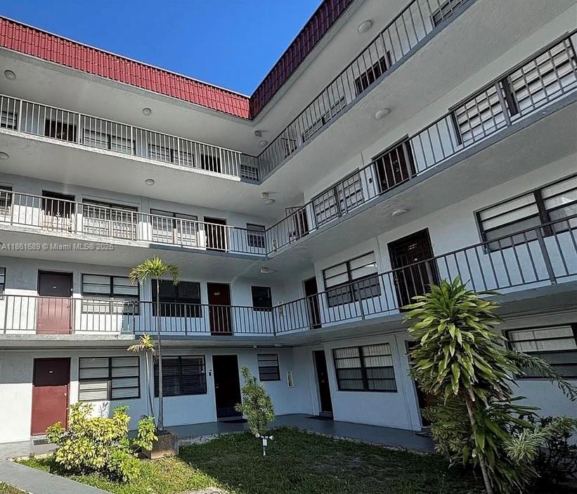 a front view of residential houses with yard