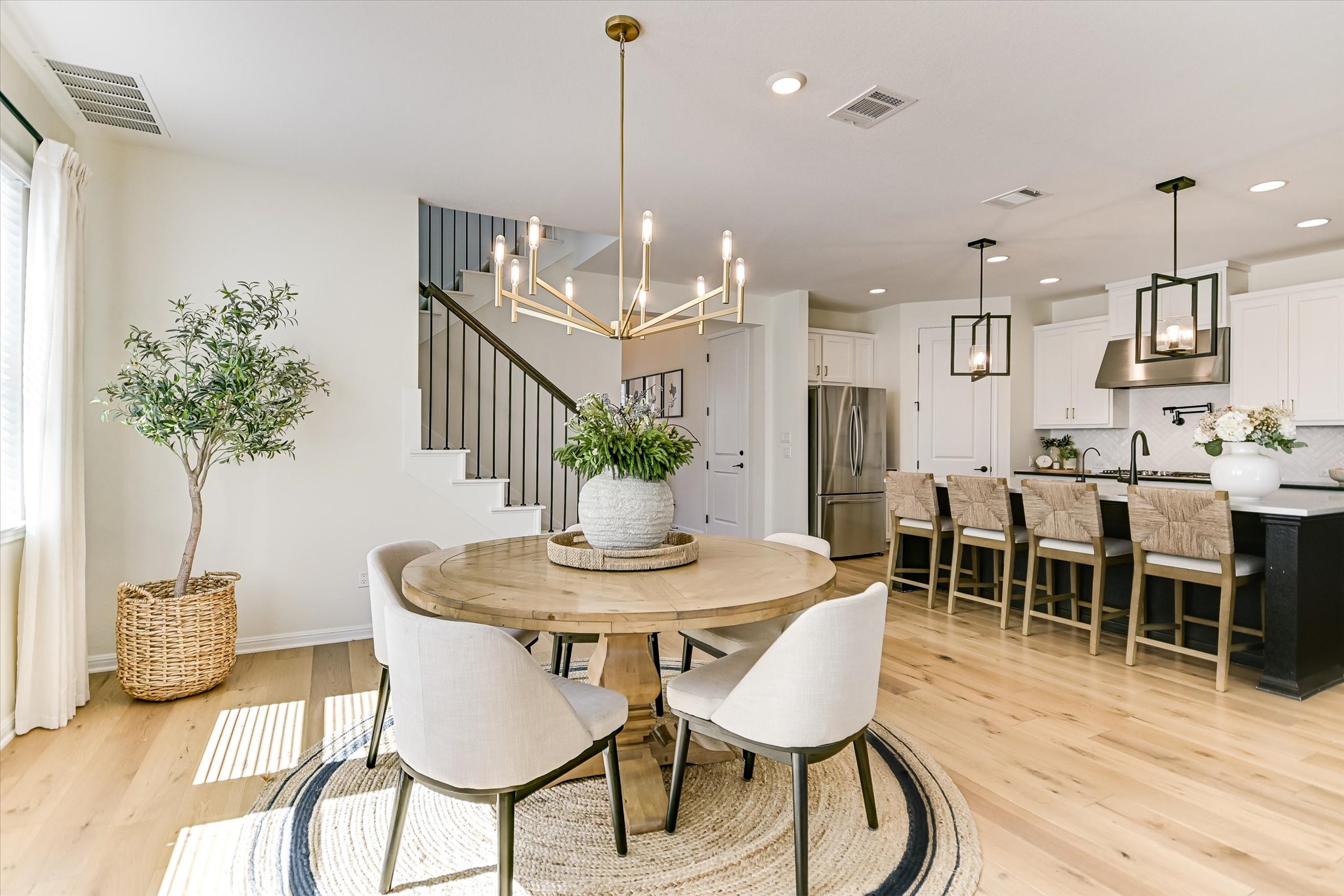 1928 Varese Path Leander, TX 78641 - Photo 5 of 31 a dining room with furniture a chandelier and wooden floor