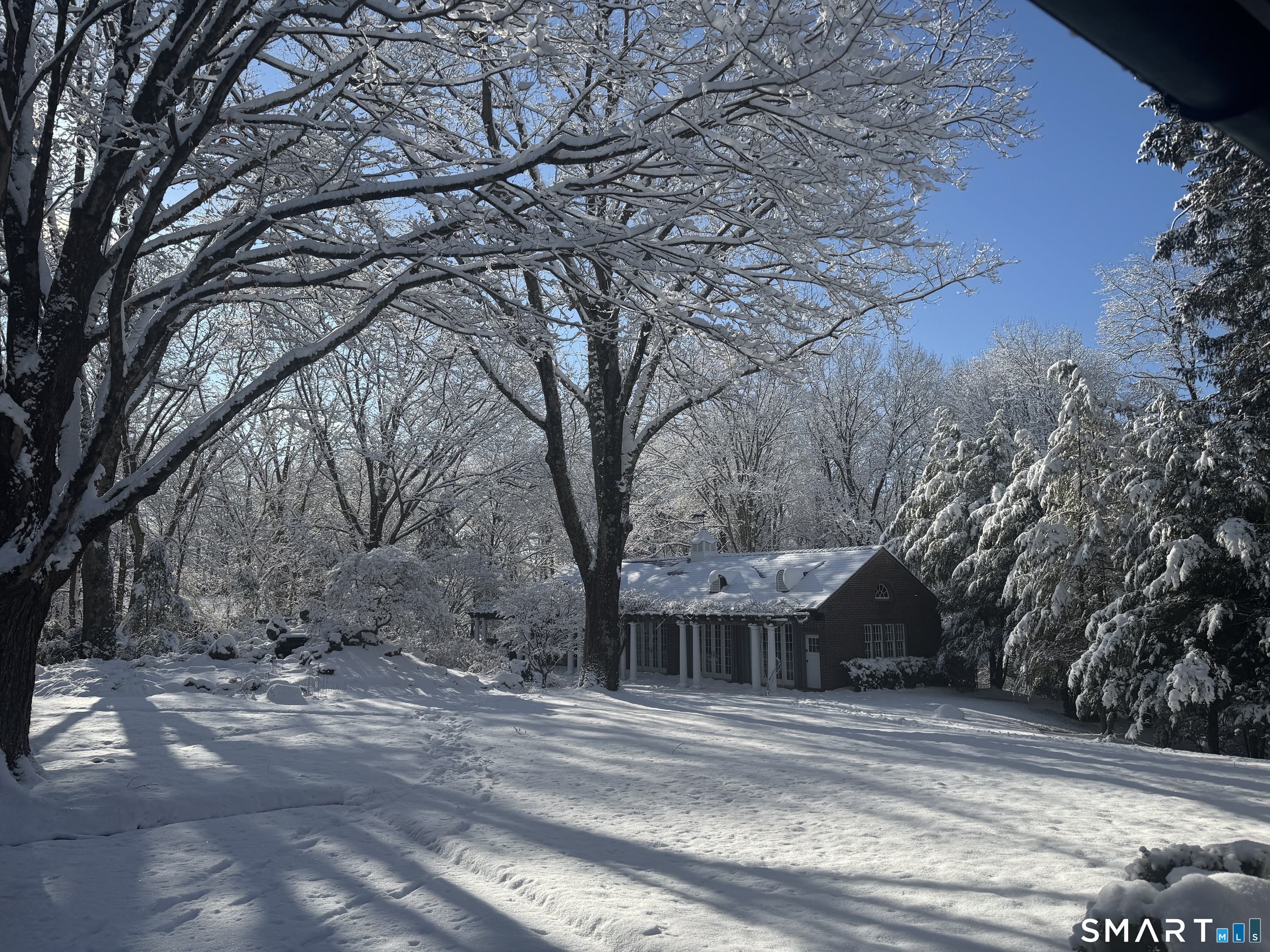 214 Good Hill Road Weston, CT 06883 - Photo 12 of 37 a view of a house with a trees in the background