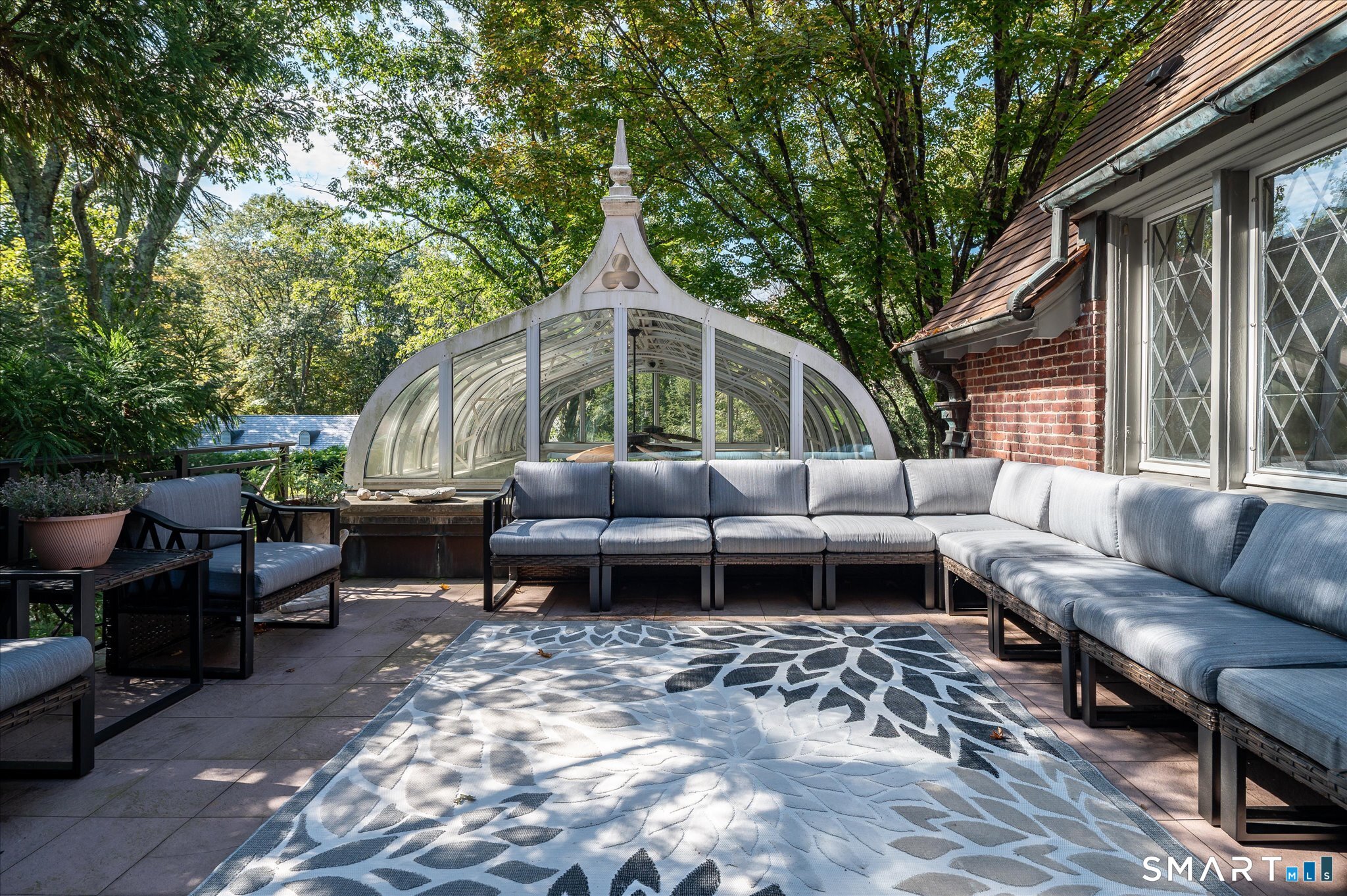 214 Good Hill Road Weston, CT 06883 - Photo 20 of 37 a backyard of a house with barbeque oven and outdoor seating