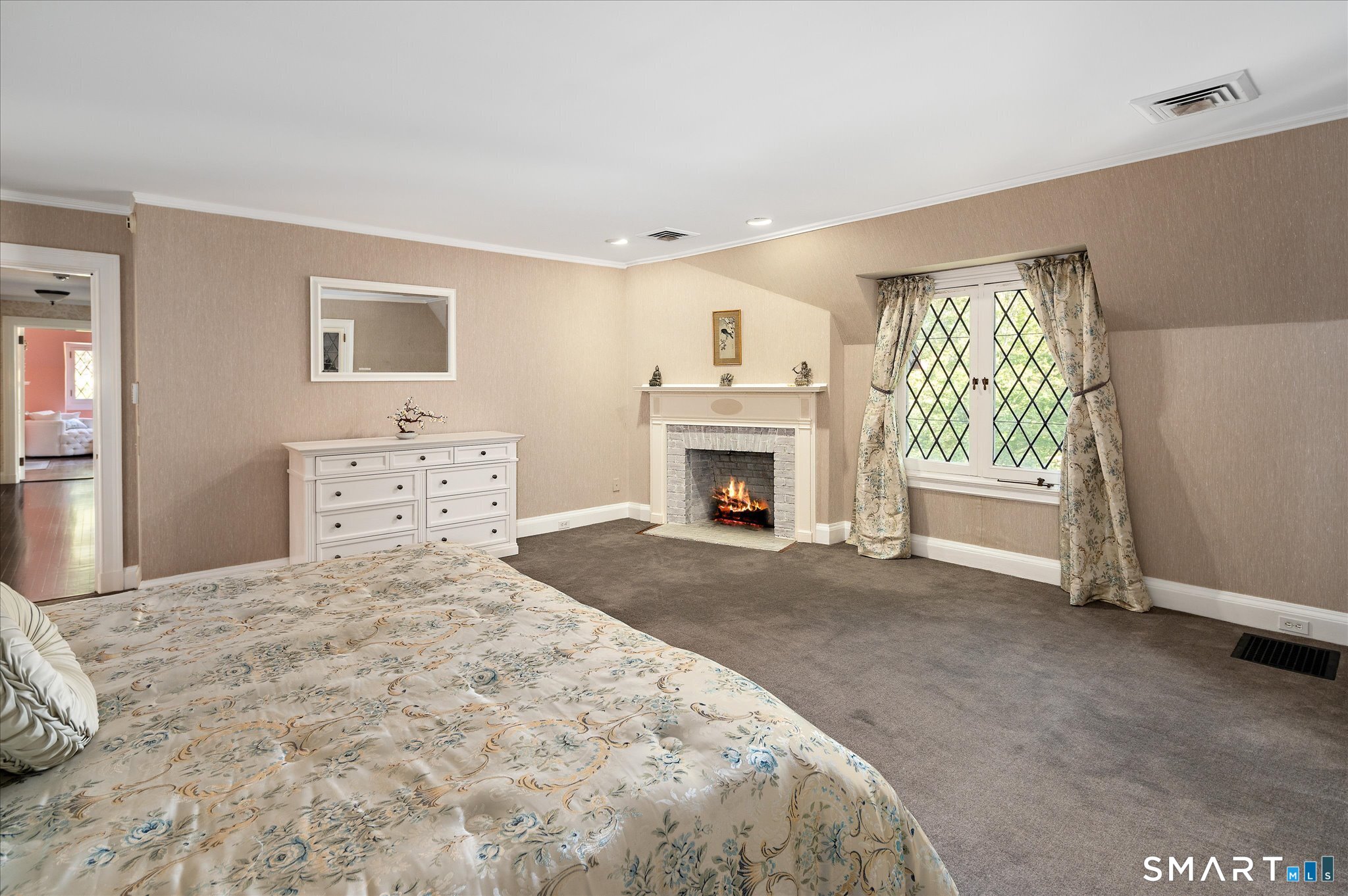 214 Good Hill Road Weston, CT 06883 - Photo 21 of 37 a bedroom with a bed and a fireplace