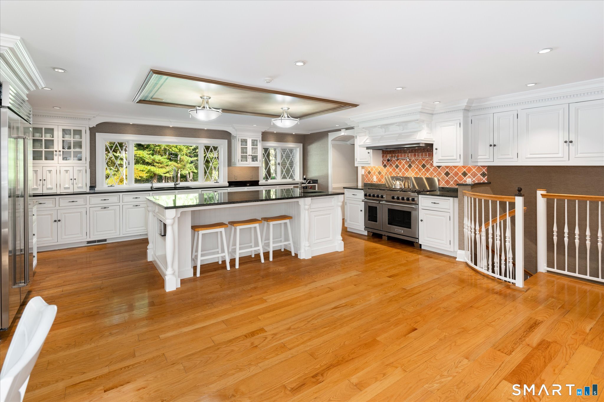 214 Good Hill Road Weston, CT 06883 - Photo 23 of 37 a large kitchen with stainless steel appliances granite countertop a stove and cabinets