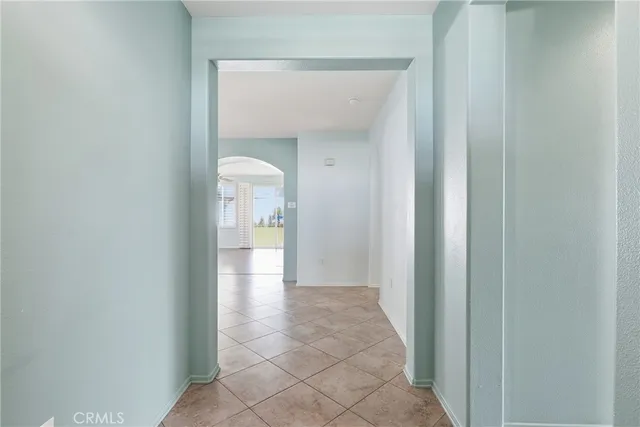 a view of a hallway with wooden shelves