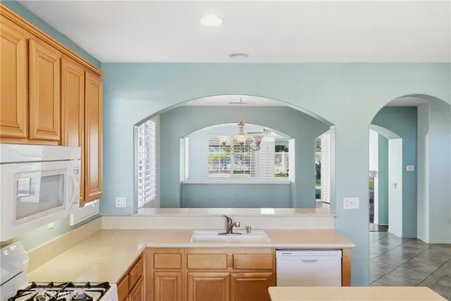 a bathroom with a granite countertop sink a mirror and a bathtub