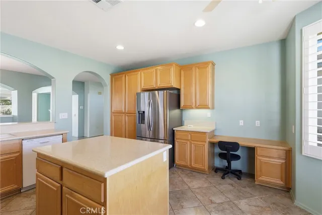 a kitchen with cabinets and refrigerator