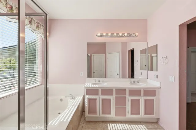 a bathroom with a bathtub sink and mirror
