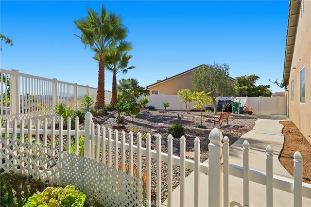 a view of a house with wooden fence