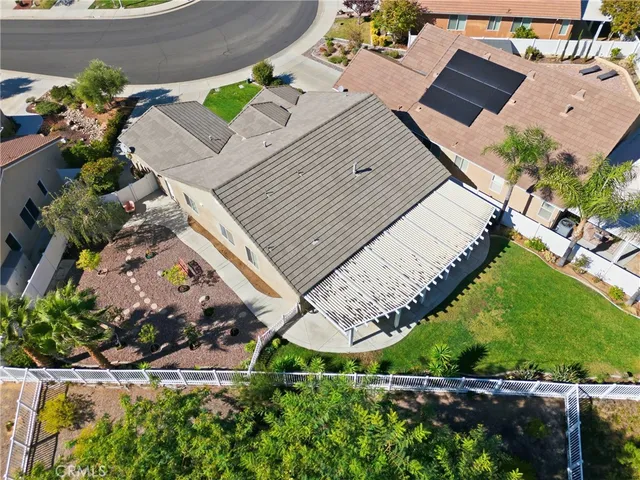 an aerial view of a house with a yard