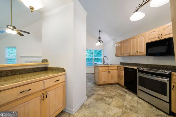 a kitchen with a stove microwave and cabinets