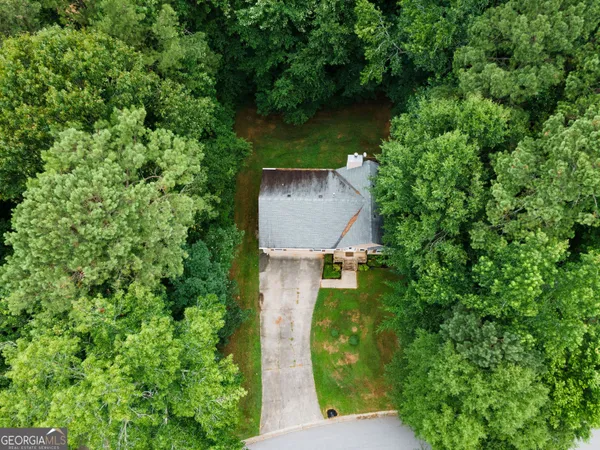 an aerial view of a house with pool outdoor seating and yard
