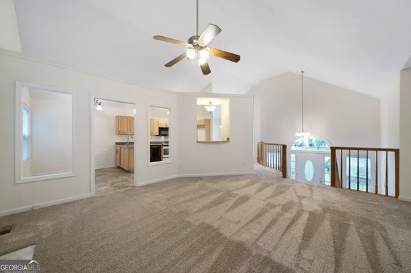 a view of a livingroom with a ceiling fan and window