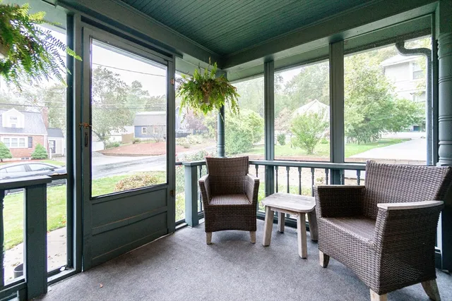 a living room with furniture and a floor to ceiling window
