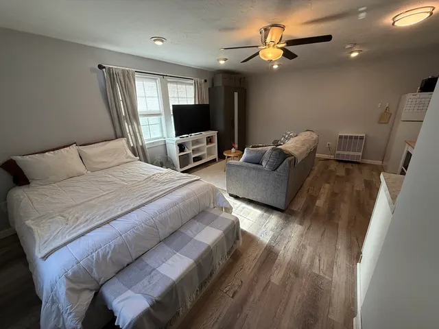 a bedroom with a bed and a flat screen tv